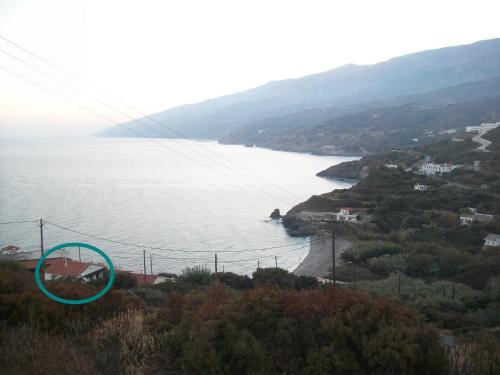 a view of a body of water with a blue circle at The House of Summer Winds in Évdhilos