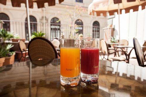 a glass of juice sitting on top of a table at Albergo del Golfo in Naples