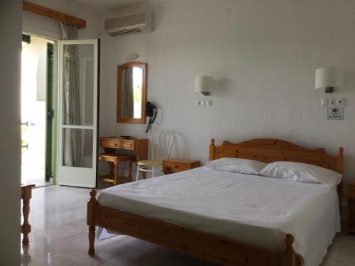 a bedroom with a bed and a room with a table at Villa Yiannis (Adult Friendly) in Megali Ammos