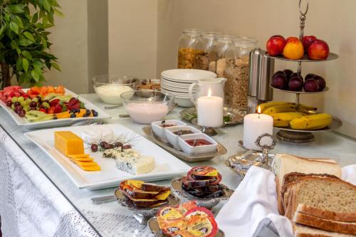 a buffet of food with bread and fruit and candles at De Hoek Manor in Stellenbosch