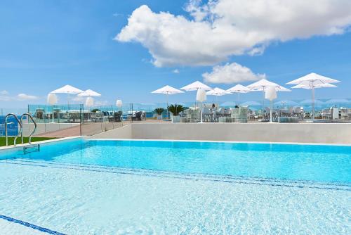 a swimming pool with a view of the ocean at Eurostars Ibiza in Ibiza Town