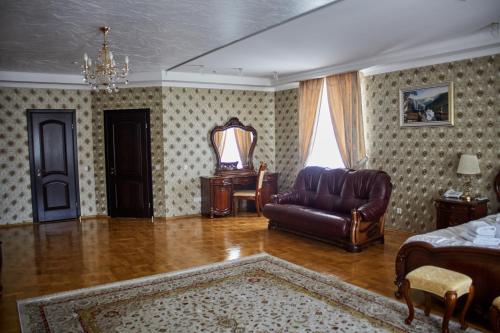 a living room with a couch and a mirror at Garden Hall in Ternopilʼ
