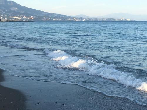 a beach with waves coming in from the ocean at Apartment with private patio in Fuengirola
