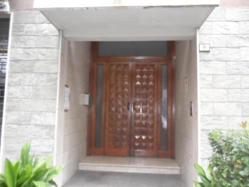 a wooden door in a building with a stone wall at Guest House Vecchi in Reggio Emilia