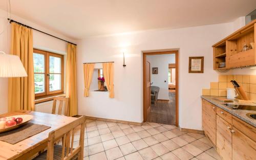 a kitchen with a table and a dining room at Naturresidenz Mair Zu Hof in Campo Tures