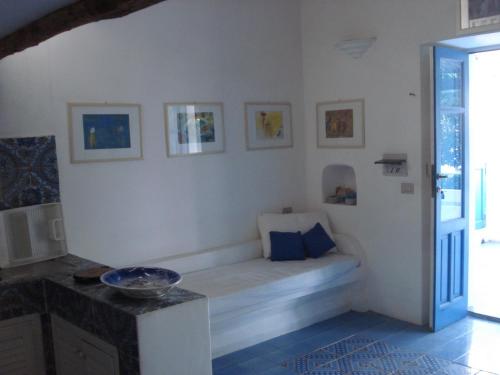 a white room with a bench in the corner at Villa in Panarea - Nespolo in Panarea