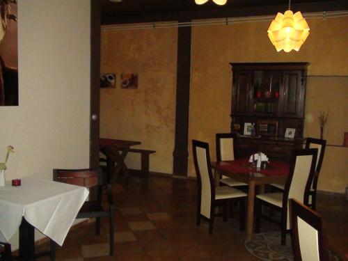 a dining room with a table and chairs and a chandelier at Hotel Europa in Polanica-Zdrój