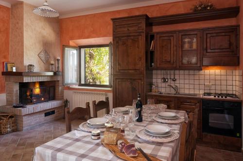 a kitchen with a table with plates on it at Agriturismo San Marcello in Castiglione dʼOrcia