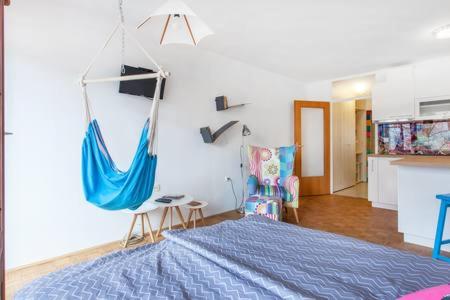 a bedroom with a swing hanging from the wall at Apartment Living Colors in Ljubljana