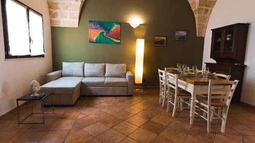a living room with a couch and a table at La Casetta in Calimera