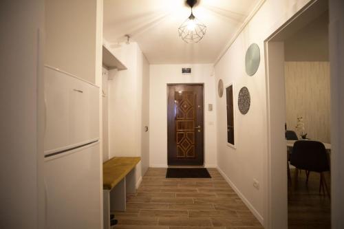 a hallway with a door and a table in a room at SMP apartment 3 in Timişoara