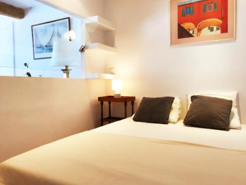 a bedroom with a bed with two pillows on it at Le Palmyre in Cassis