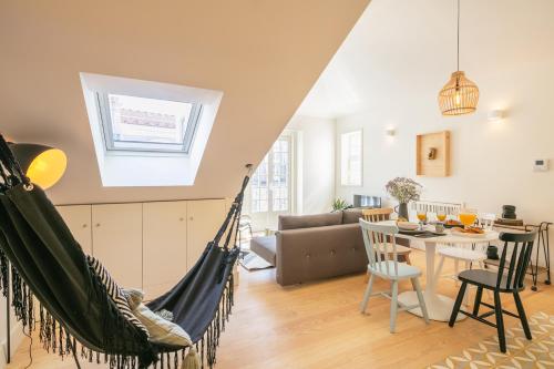a living room with a hammock in a room at Almaria - Officina Real Apartments | Chiado in Lisbon