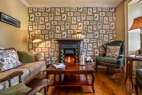 a living room with a couch and a fireplace at Carrig Country House & Restaurant in Killorglin