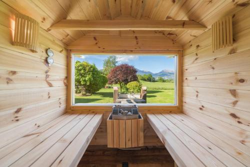 a wooden room with a window in a log cabin at Apartment Wellness Essense in Bled