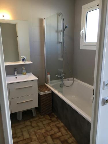 a bathroom with a shower and a sink and a tub at Villa rapatel in Saint Cyprien Plage