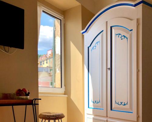 a white cabinet in a room with a window at Orto al Mare Room Rental in Riomaggiore