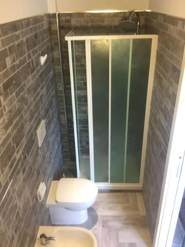 a bathroom with a toilet and a glass shower at Beb la lupa in Rome