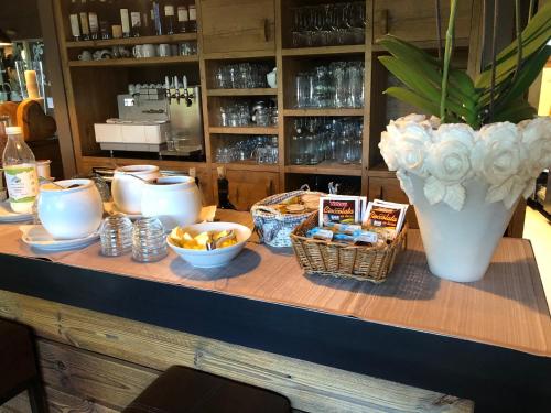 a table with baskets of food and a vase at La Tresenda Hotel and Mountain Farm in Livigno