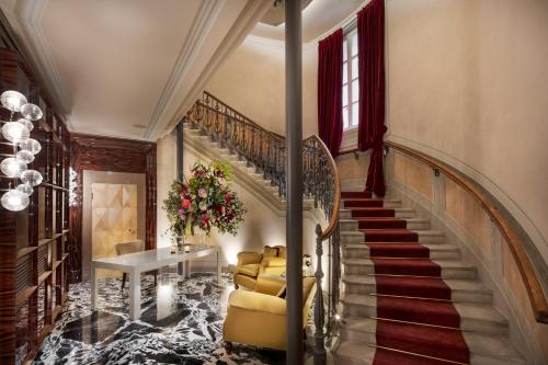 a hallway with a staircase with a couch and a table at VISTA Lago di Como in Como