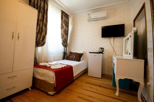 a hotel room with a bed and a tv at Paris Garden Hotel Istanbul in Istanbul