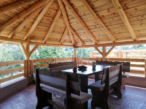 einen Holzpavillon mit einem Tisch und Stühlen in der Unterkunft Rtanjski konak in Boljevac