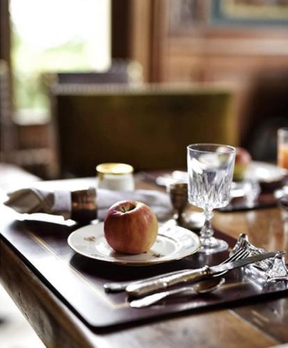 une pomme sur une plaque sur une table dans l'établissement Monastere de Brucourt, à Brucourt