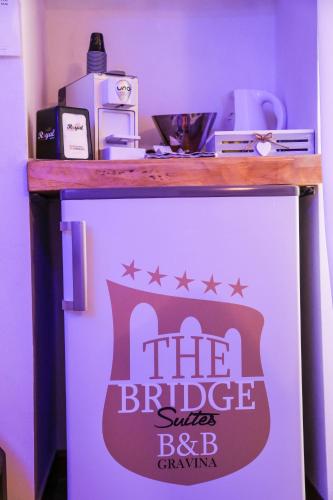 a white refrigerator with a sign on top of it at The Bridge Suites in Gravina in Puglia