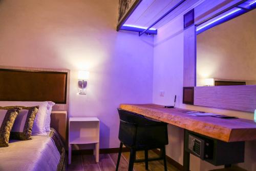 a hotel room with a desk and a bed at The Bridge Suites in Gravina in Puglia