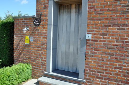 a brick building with a door on the side of it at B&B Pierre-Marie in Bovekerke