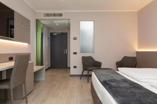 a hotel room with a bed and a desk at Garda Life in Riva del Garda