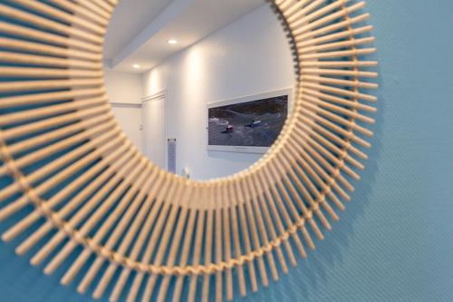 a mirror on a wall in a room at Citotel Le Regina Bordeaux Gare Saint-Jean in Bordeaux