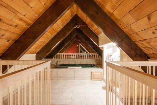 an attic kitchen with wooden ceilings and a staircase at North Lake Lodges & Villas in Incline Village