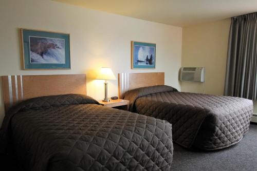 a hotel room with two beds in a room at Breeze Inn Motel in Seward