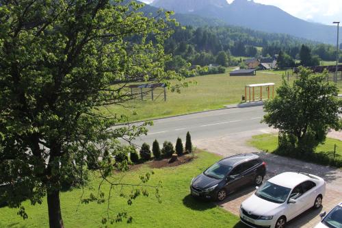 two cars parked on the side of a road at Apartma Maržič in Kranjska Gora