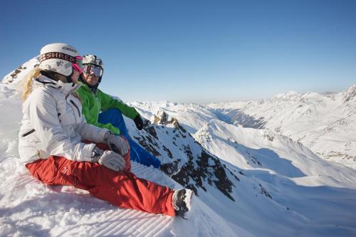 two people sitting on top of a snow covered mountain at Haus Kaunergrat in Kaunertal