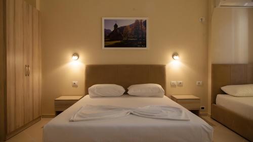 a bedroom with a bed with a robe on it at Villa Balani in Durrës