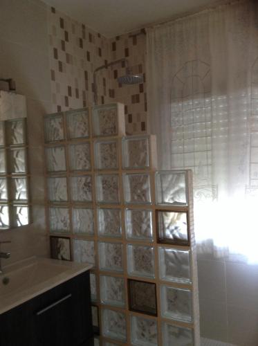 a bathroom with a wall of pictures on the wall at La torre in Rodonyà