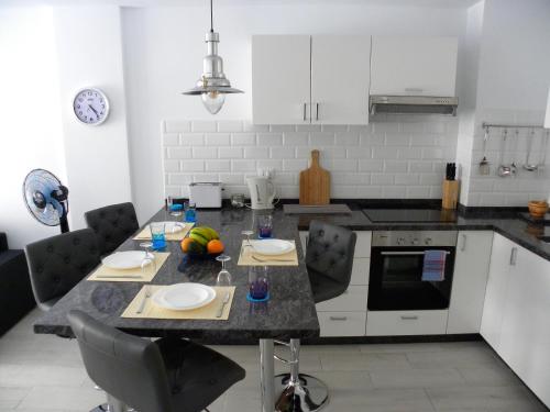 Кухня или мини-кухня в BEN'SHOLIDAYFLAT Ideal for families groups and couples Terrace Solarium Wi-Fi Netflix Smart TV
