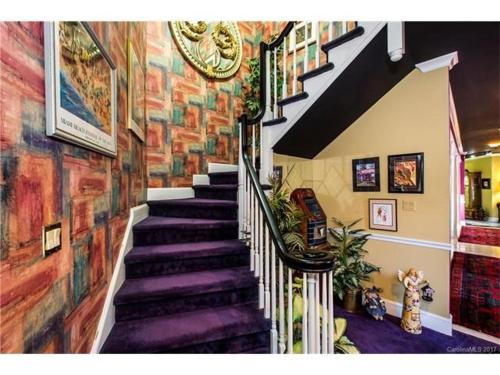 a spiral staircase in a building with a mural at Matthews Manor Bed & Breakfast in Charlotte