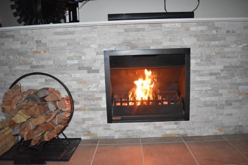 a brick fireplace with a fire in it at Mapleton Springs in Mapleton