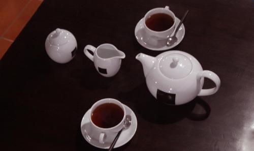 a group of cups and saucers of coffee on a table at Blue Pillars Kandy in Kandy