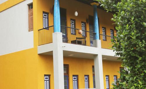 a person sitting on a balcony of a building at Blue Pillars Kandy in Kandy