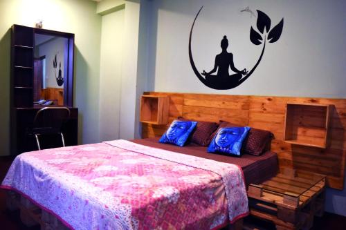 a bedroom with a bed with blue pillows at Yog Hostel- Rooftop Yoga & Backpacker Social Stay in Thamel, Kathamndu in Kathmandu