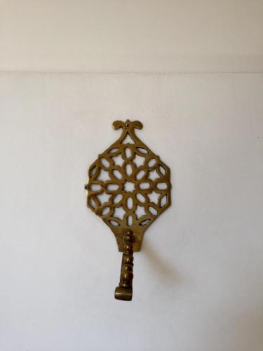 a gold object hanging on a wall at Riad Tizwa Marrakech in Marrakech