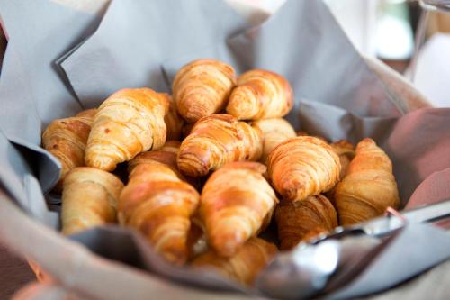 a bunch of croissants sitting in a basket at Kyriad Limoges Sud - Feytiat in Feytiat