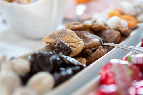 a tray of different types of donuts on a table at Kyriad Limoges Sud - Feytiat in Feytiat