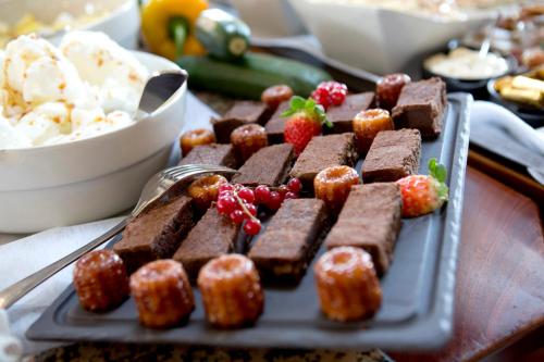 a tray of brownies and strawberries on a table at Kyriad Limoges Sud - Feytiat in Feytiat