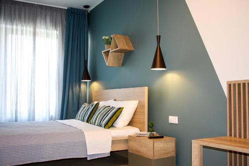 a bedroom with a bed and a lamp at Dynasta Central Suites in Athens