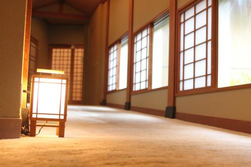an empty room with windows and a sign in the middle at Yutorelo Toyako in Lake Toya